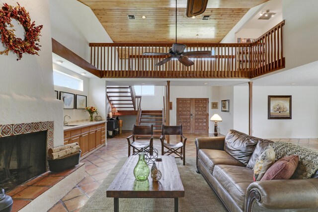 living room with visible vents, wooden ceiling, ceiling fan, stairway, and high vaulted ceiling