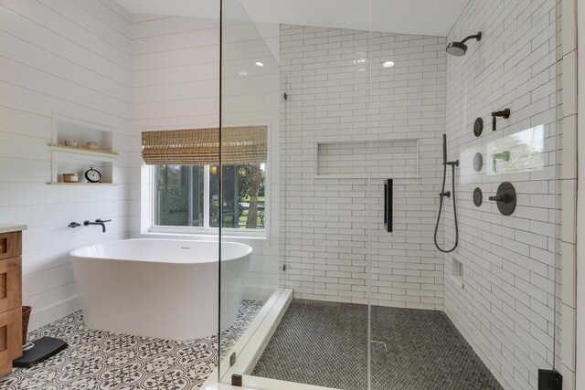 full bath with lofted ceiling and a shower stall