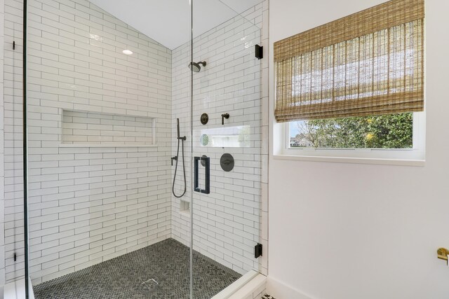 bathroom with a water view and a freestanding bath