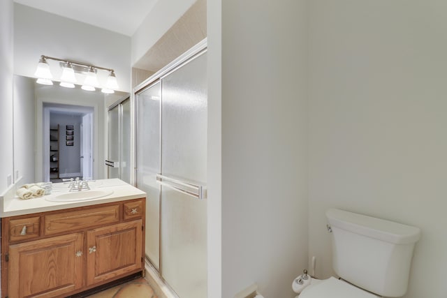 bathroom featuring vanity, toilet, and walk in shower