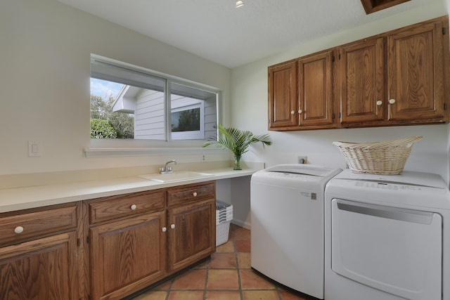 laundry area with cabinets, separate washer and dryer, light tile patterned flooring, and sink