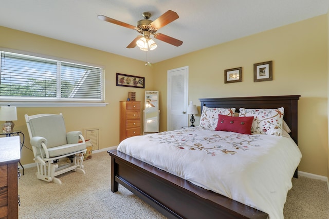 carpeted bedroom with a closet and ceiling fan