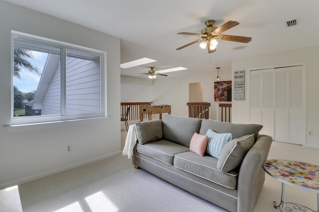 recreation room with a ceiling fan, light colored carpet, visible vents, and baseboards