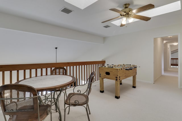 recreation room with ceiling fan and light colored carpet