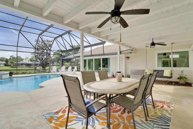 view of pool with a patio and glass enclosure