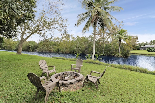 view of yard featuring a water view and an outdoor fire pit