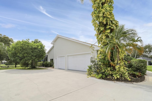 view of home's exterior featuring concrete driveway