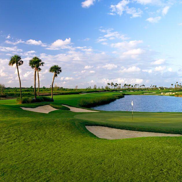 view of community featuring view of golf course, a water view, and a yard