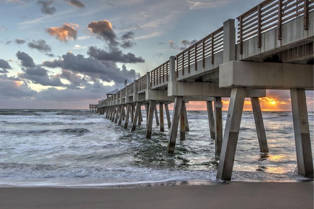 view of property's community featuring a pier and a water view