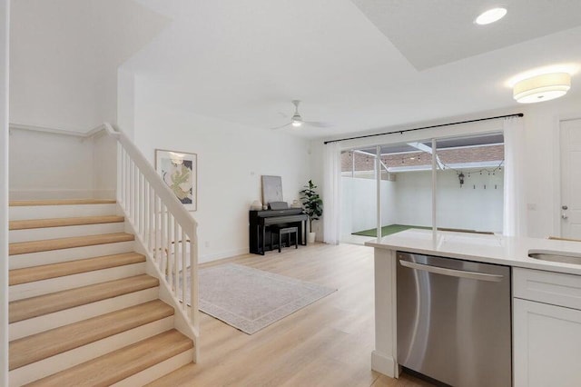 kitchen featuring dishwasher, white cabinetry, light wood-type flooring, and ceiling fan