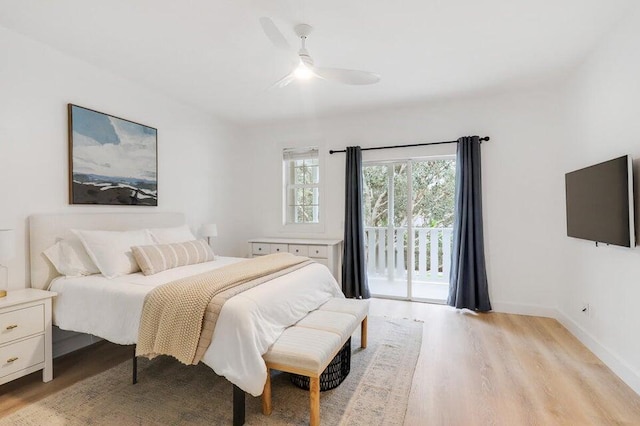 bedroom featuring access to exterior, light hardwood / wood-style floors, and ceiling fan