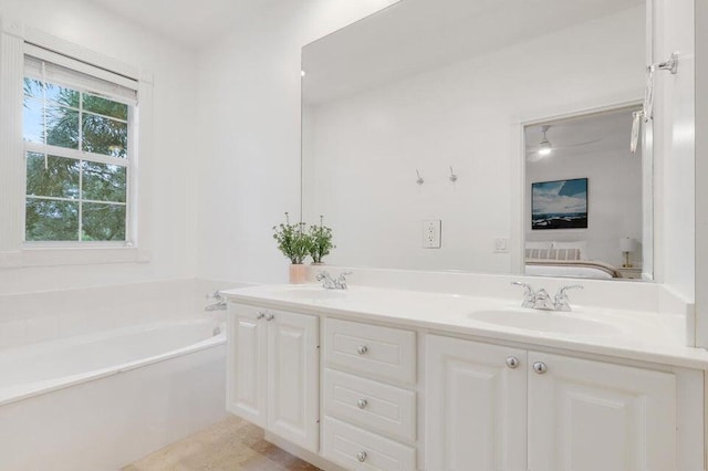 bathroom featuring vanity and a bath