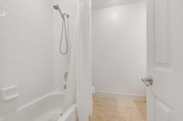 bathroom with toilet and shower / tub combo with curtain