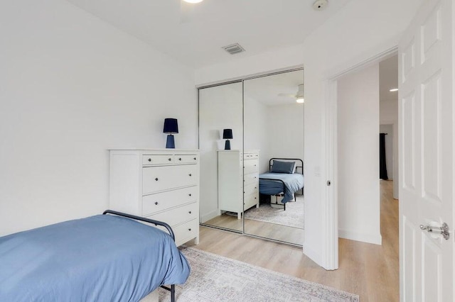 bedroom featuring a closet and light wood-type flooring