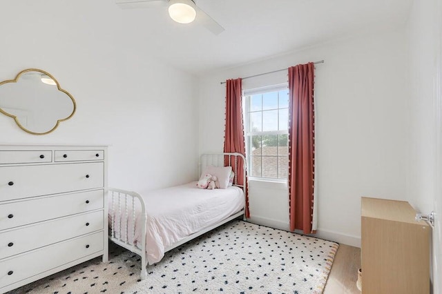 bedroom with light hardwood / wood-style floors and ceiling fan