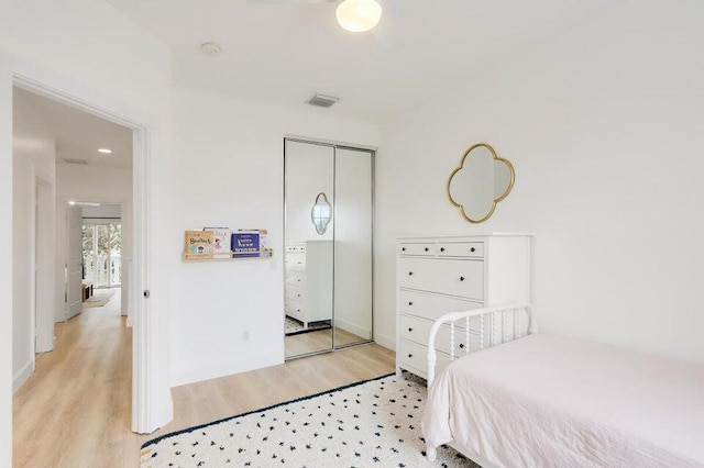 bedroom with a closet and light hardwood / wood-style flooring