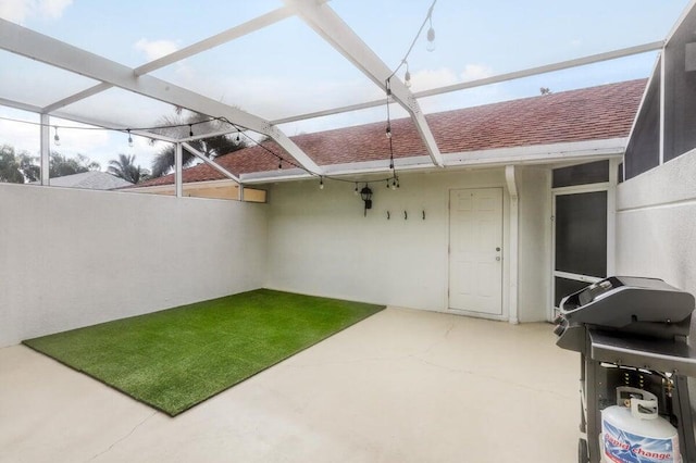 view of patio with glass enclosure