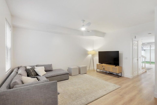 living room with wood-type flooring and ceiling fan