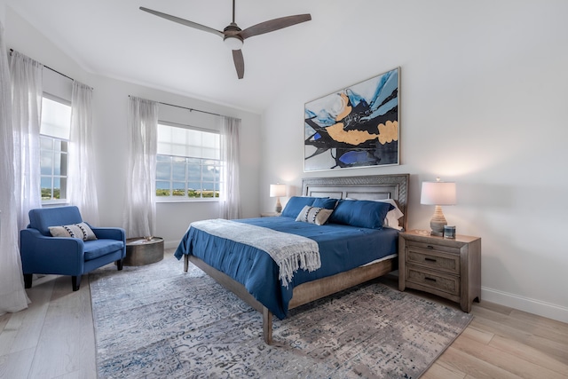 bedroom featuring light wood-type flooring, ceiling fan, and lofted ceiling