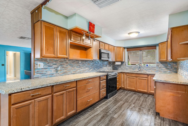 kitchen with light stone counters, kitchen peninsula, tasteful backsplash, dark wood-type flooring, and black range with electric cooktop