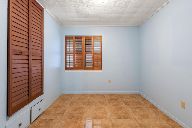 unfurnished room with light tile patterned flooring and crown molding