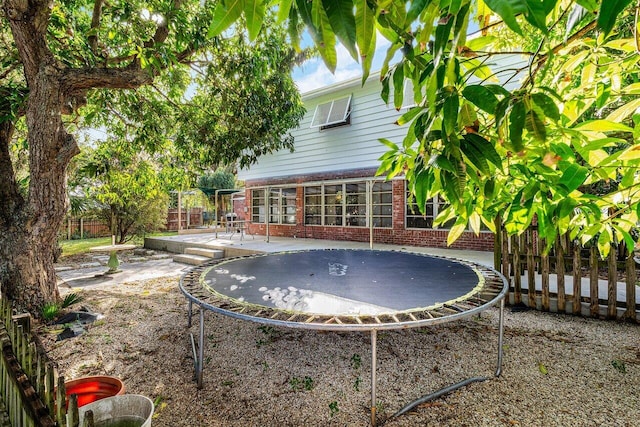 view of yard featuring a patio and a trampoline