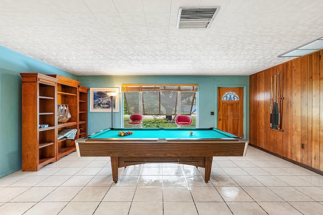 recreation room with wood walls, light tile patterned flooring, and pool table