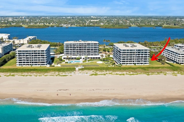 drone / aerial view with a water view and a view of the beach