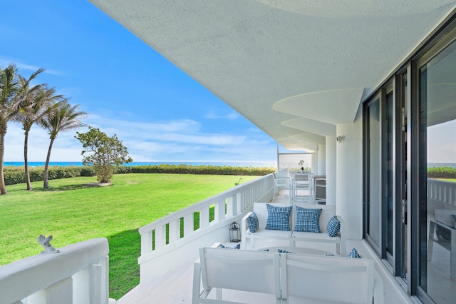 balcony with an outdoor living space and a water view