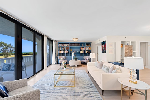 living room featuring light hardwood / wood-style flooring and floor to ceiling windows