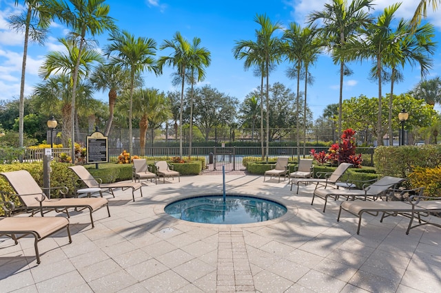 view of pool with a community hot tub and a patio