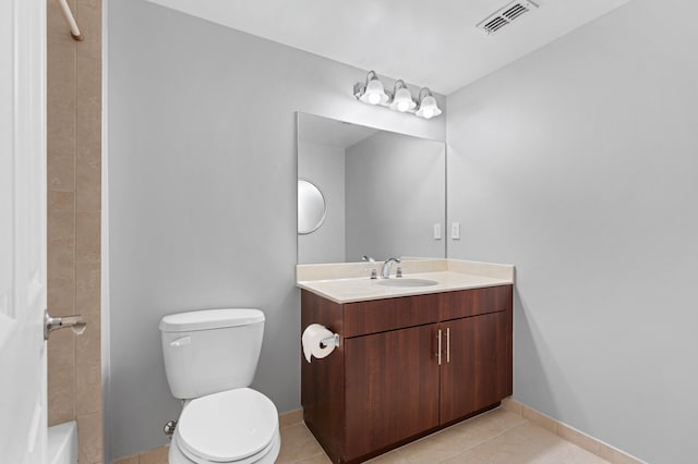 full bathroom with toilet, vanity, tiled shower / bath, and tile patterned flooring