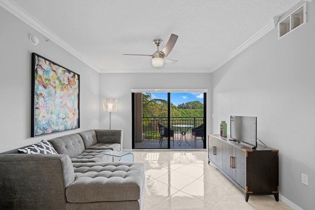 tiled living room with ornamental molding and ceiling fan