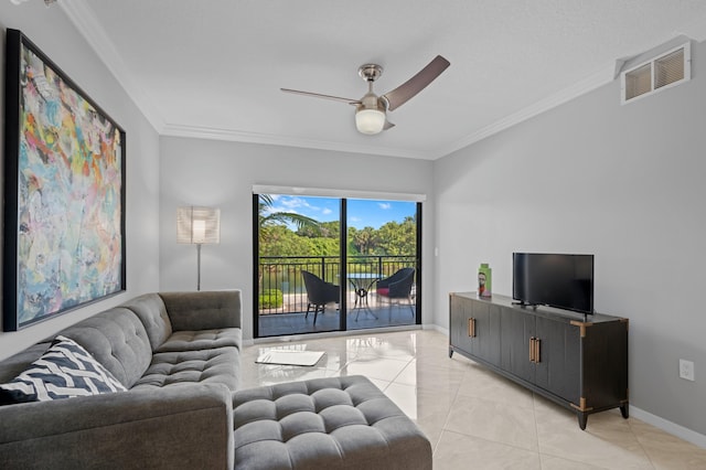 tiled living room with ornamental molding and ceiling fan