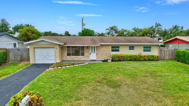 single story home with a garage and a front lawn