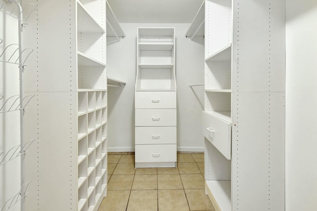 spacious closet featuring light tile patterned flooring