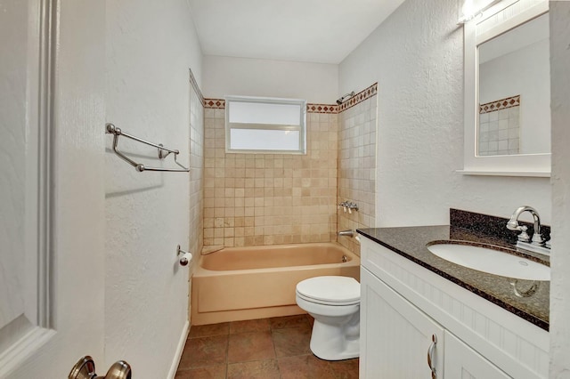 full bathroom featuring vanity, tiled shower / bath combo, and toilet