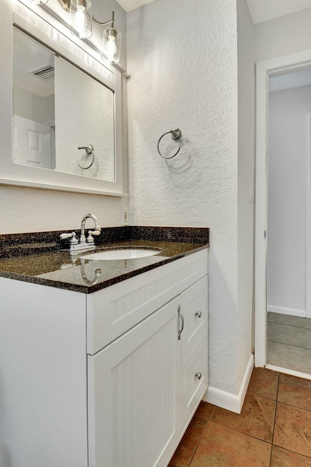 bathroom featuring tile patterned flooring and vanity