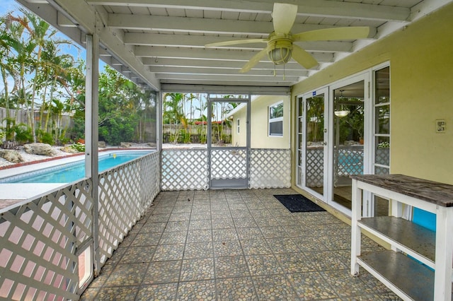 unfurnished sunroom with beamed ceiling, ceiling fan, and wooden ceiling