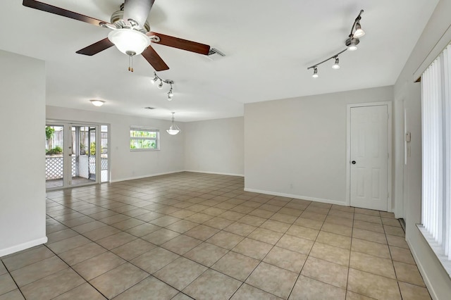 tiled spare room with ceiling fan and rail lighting