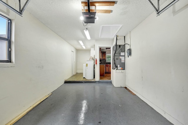 garage featuring heating unit and water heater