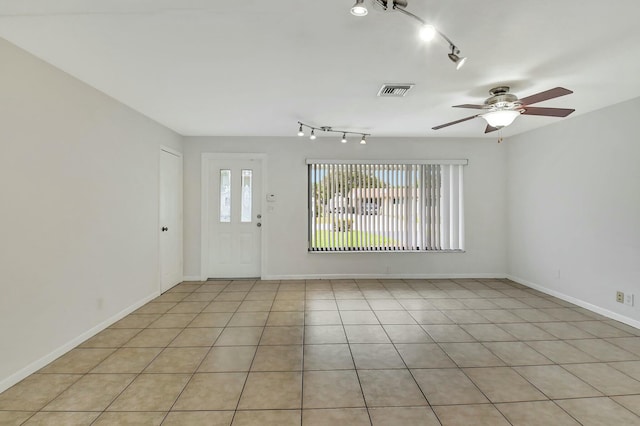 interior space with ceiling fan, light tile patterned flooring, and rail lighting