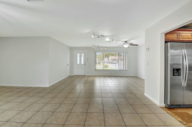 unfurnished living room featuring ceiling fan and light tile patterned floors