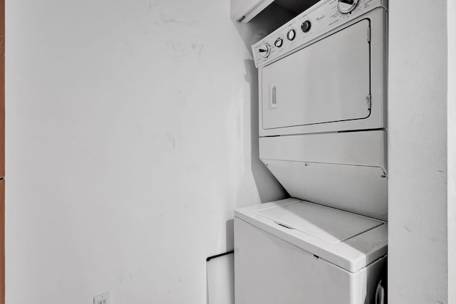 washroom featuring stacked washer / dryer