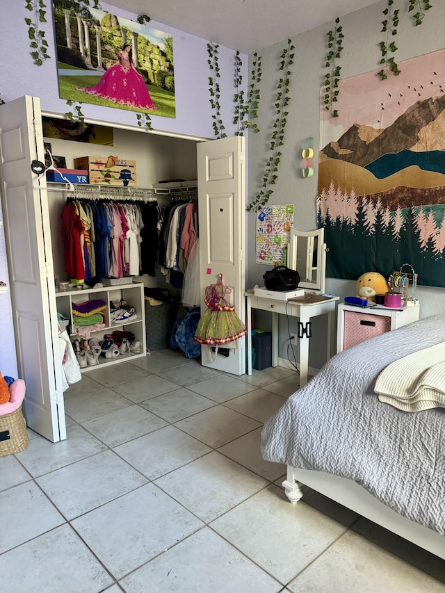 bedroom featuring tile patterned floors and a closet