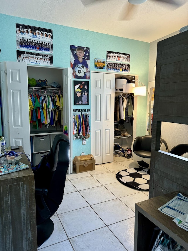 tiled bedroom with ceiling fan