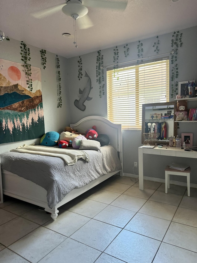 tiled bedroom featuring ceiling fan