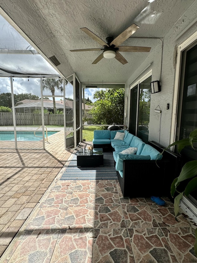 view of patio featuring outdoor lounge area, a fenced in pool, and ceiling fan