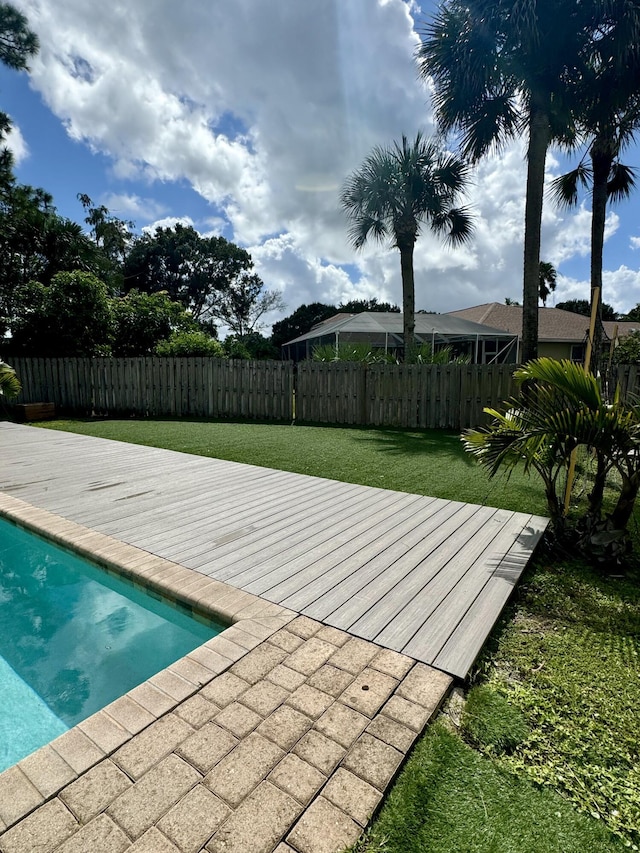 view of swimming pool with a lawn