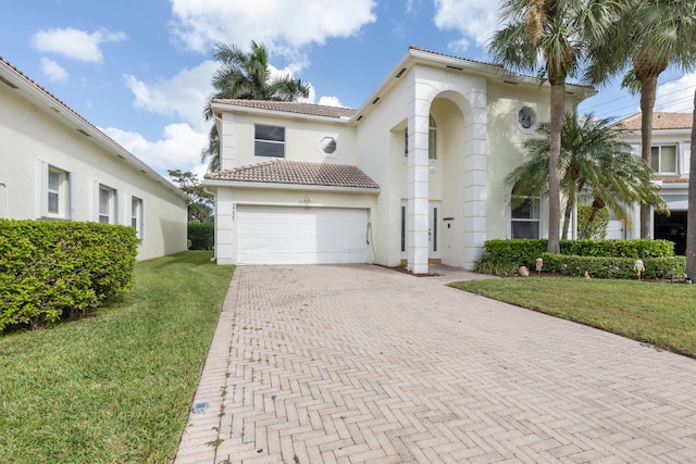 mediterranean / spanish-style house with a front yard